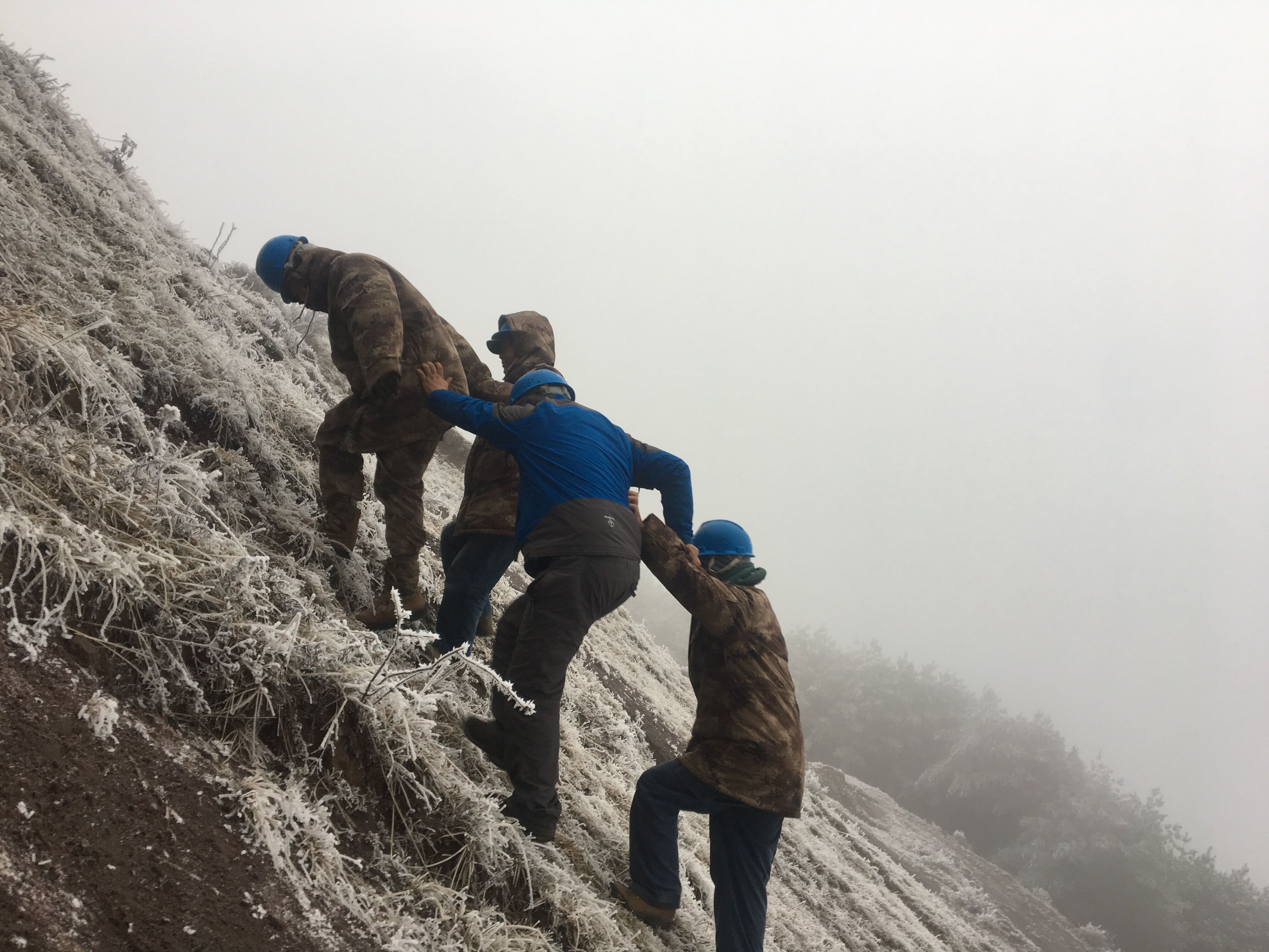 互相攙扶，勇登高峰。（李健攝）